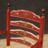 Dutch armchair in red painted wood with floral decorations