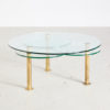 Roundish coffee table on brass legs