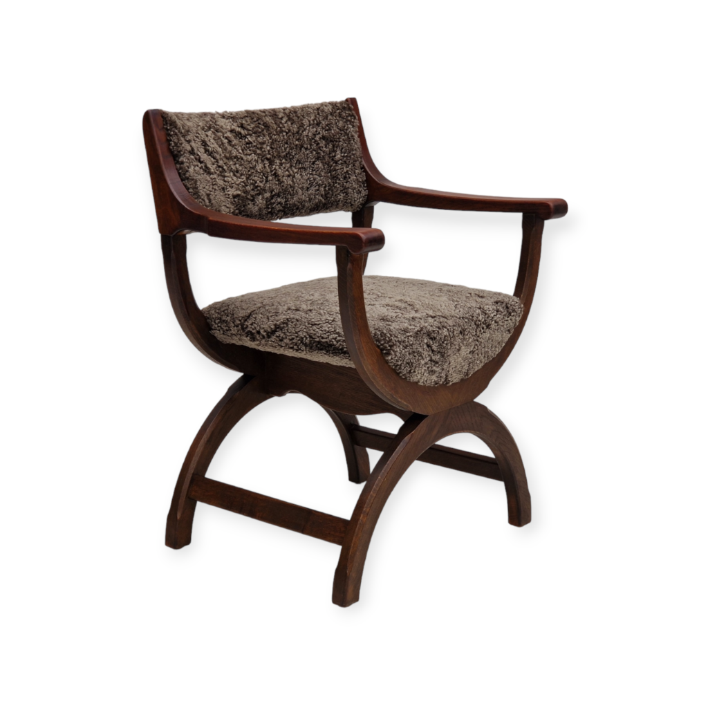 1960s, Danish design by Henning Kjærnulf, chair model “Kurul”, sheepskin, dark oak.