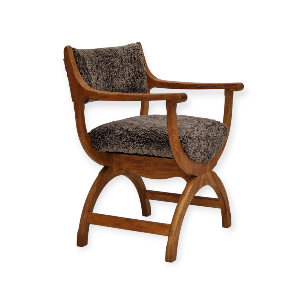 1960s, Danish design by Henning Kjærnulf, chair model “Kurul”, sheepskin, oak wood.